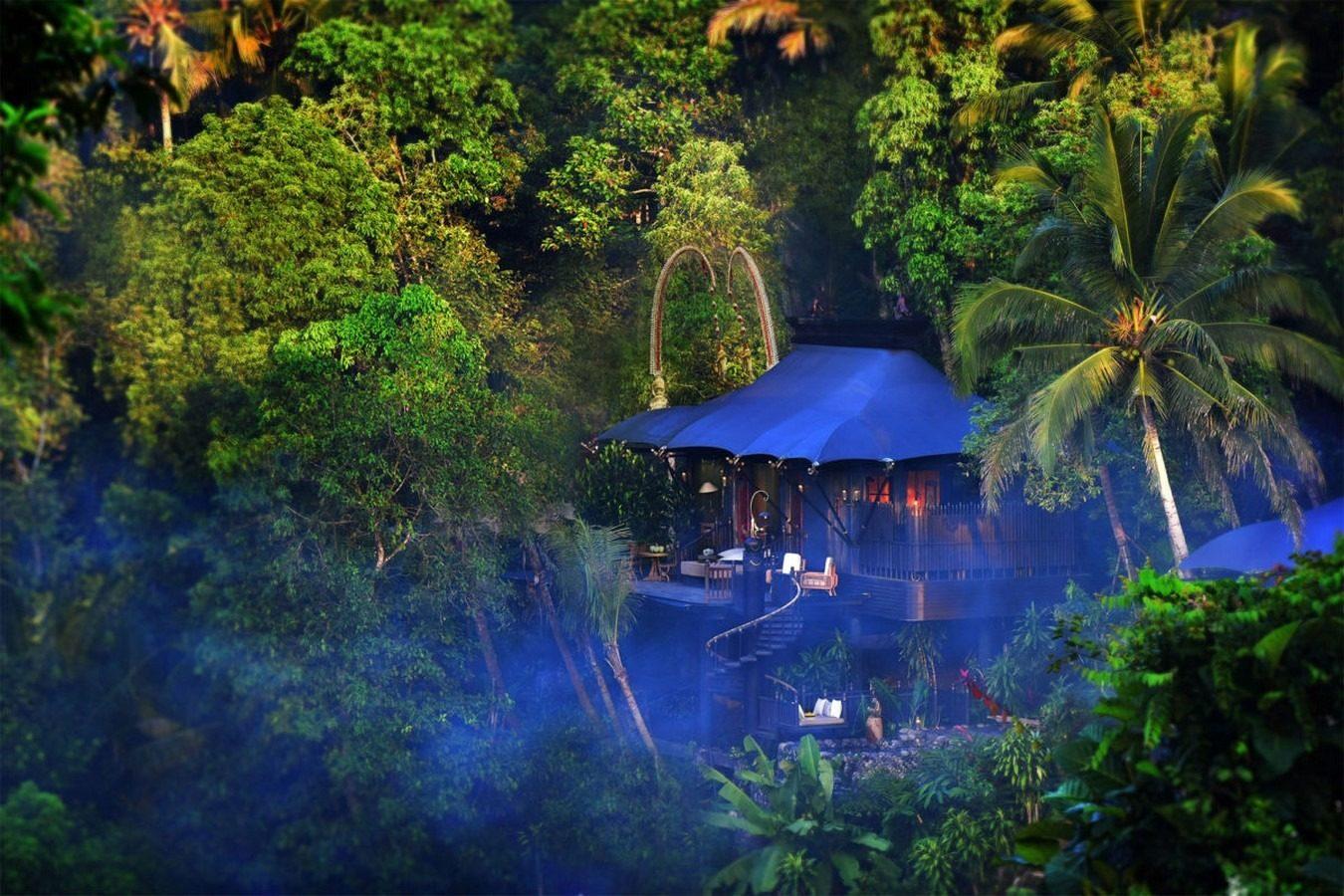 A tented suite at Capella Ubud standing alone among the trees