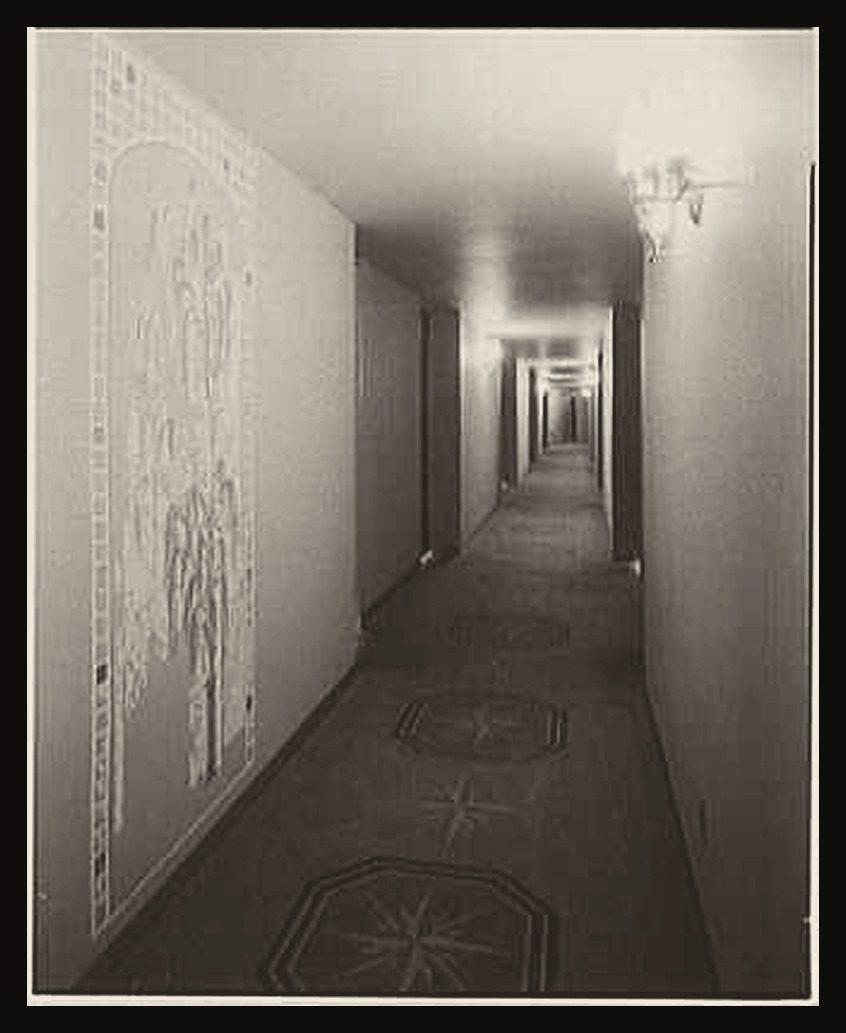 A long hotel corridor lined with identical doors at the Americana Hotel, New York, 1963