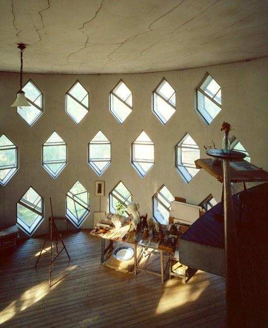 Inside Melnikov's studio: hexagonal windows in a curved wall above a drawing table