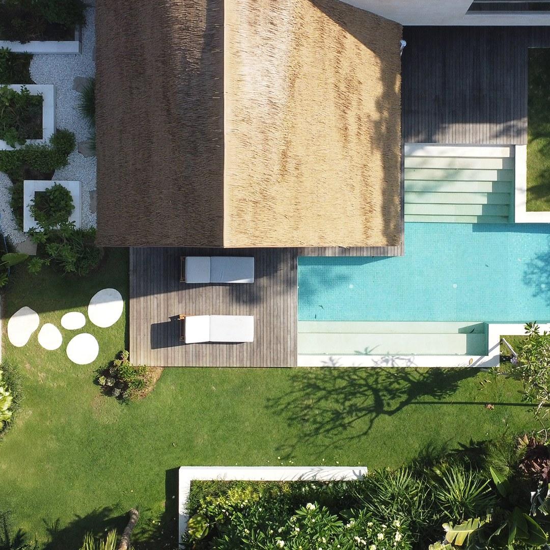 Aerial render of the Thorp House garden showing the thatched sauna roof, deck, pool and stepping stones