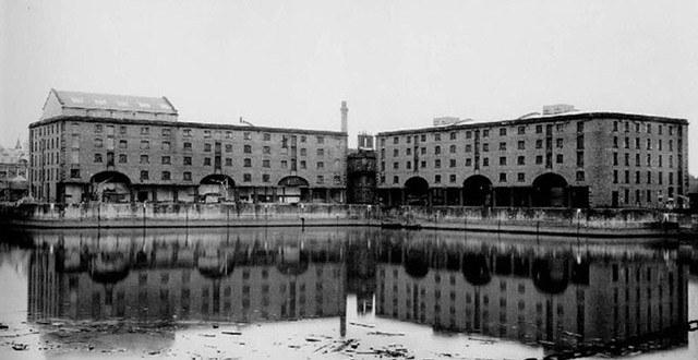 The Albert Dock warehouses in Liverpool, derelict, reflected in still water