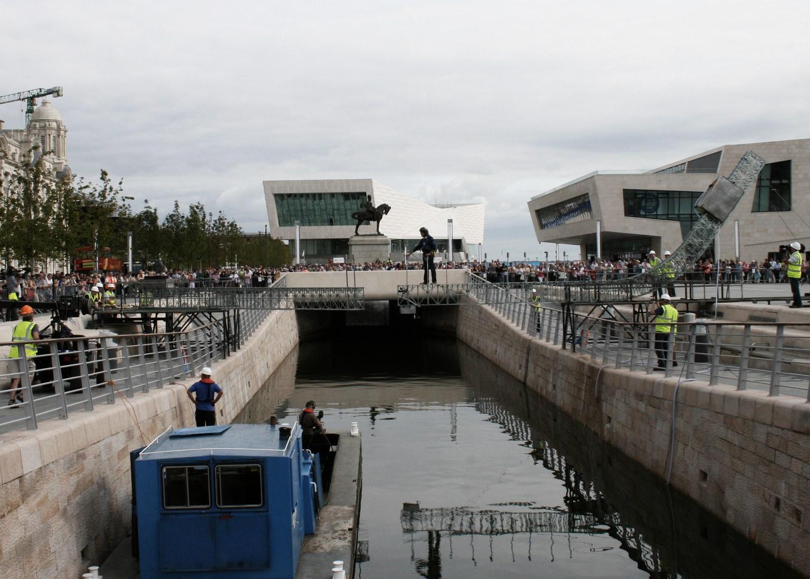 The Meccano bridge across the Pier Head canal in Liverpool with a crowd watching